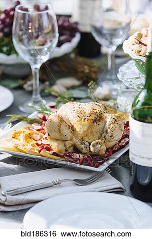 Stock Photograph - Roast chicken dinner on table. Fotosearch