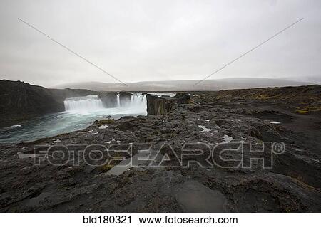 Stock Image - Rock formation cliffs near remote waterfall. Fotosearch