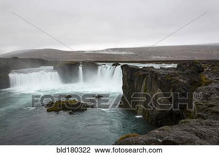 Stock Image - Rock formation cliffs near remote waterfall. Fotosearch