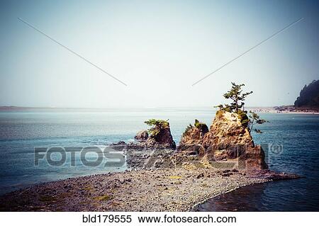 Rock formations on beach under blue sky View Large Photo Image Stock Photography - Rock formations on beach under blue sky. Fotosearch