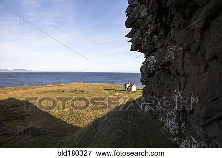 Rocky cliff over rural field and seascape View Large Photo Image Stock Photo - Rocky cliff over rural field and seascape. Fotosearch