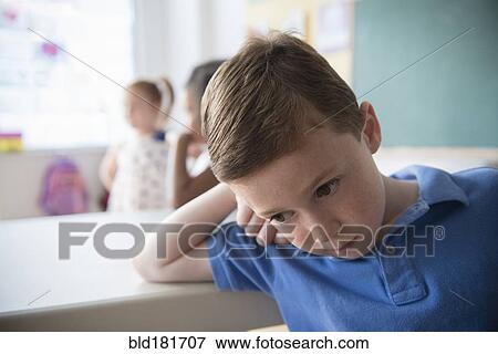 Sad student leaning on desk View Large Photo Image Stock Photo - Sad student leaning on desk. Fotosearch