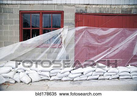 Sandbags and glass sheet on building wall View Large Photo Image Stock Photography - Sandbags and glass sheet on building wall. Fotosearch