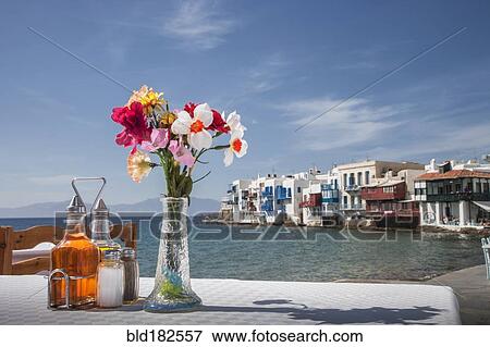 Seasonings and flowers on oceanfront cafe table View Large Photo Image Stock Photo - Seasonings and flowers on oceanfront cafe table. Fotosearch