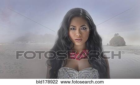 Stock Image - Serious Asian woman on beach. Fotosearch
