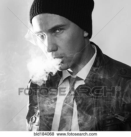 Stock Photo - Serious Caucasian man smoking. Fotosearch