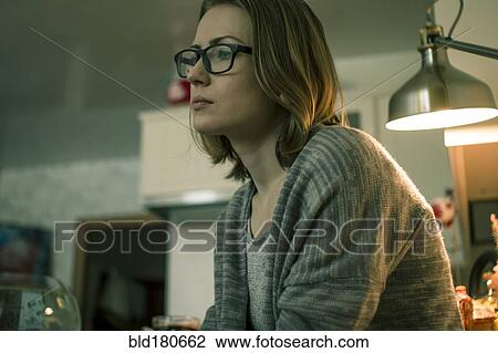 Serious Caucasian woman sitting indoors View Large Photo Image Stock Image - Serious Caucasian woman sitting indoors. Fotosearch