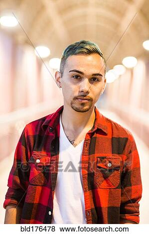Serious Hispanic man wearing flannel shirt View Large Photo Image Stock Photo - Serious Hispanic man wearing flannel shirt. Fotosearch