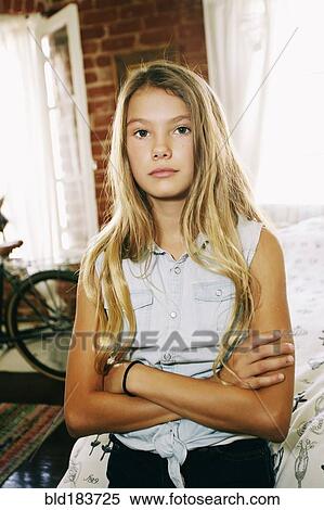 Stock Photography - Serious Native American girl with arms crossed. Fotosearch