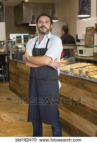 Stock Image - Server smiling in cafe. Fotosearch