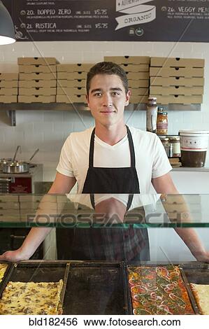 Stock Photograph - Server smiling in cafe. Fotosearch