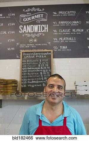 Stock Photograph - Server smiling in cafe. Fotosearch