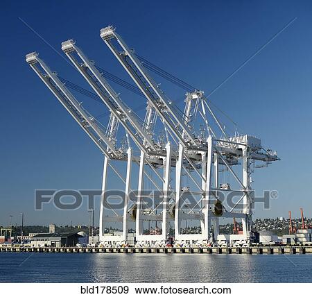Stock Photo - Shipping cranes over industrial shipyard . Fotosearch