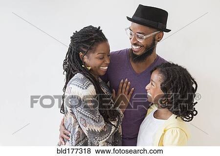 Smiling Black family hugging View Large Photo Image Stock Photo - Smiling Black family hugging. Fotosearch