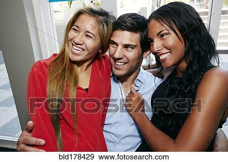 Stock Photo - Smiling friends hugging. Fotosearch