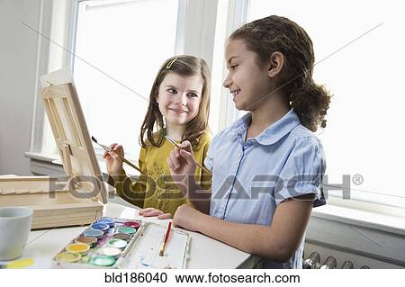Smiling girls painting View Large Photo Image Stock Image - Smiling girls painting. Fotosearch