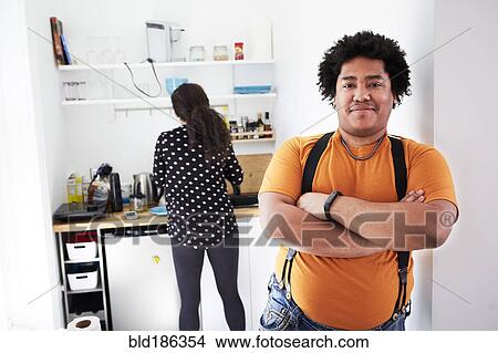 Picture - Smiling man standing with arms crossed. Fotosearch