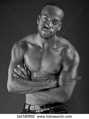Stock Image - Smiling man with arms crossed. Fotosearch