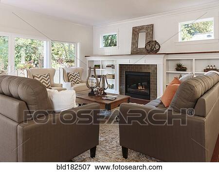 Stock Photo - Sofas and fireplace in living room. Fotosearch