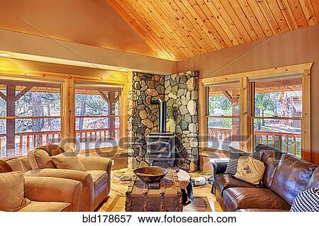 Stock Photo - Sofas and fireplace in rustic living room. Fotosearch
