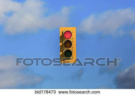Stock Image - Stoplight floating in sky. Fotosearch