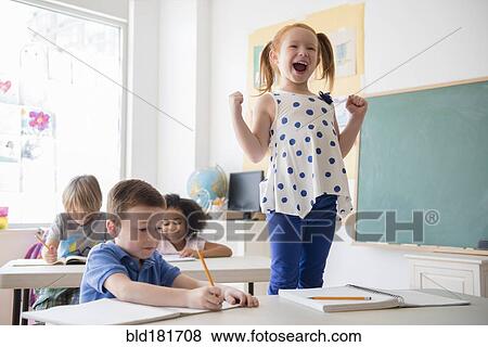 Student shouting at desk in classroom View Large Photo Image Stock Photo - Student shouting at desk in classroom. Fotosearch