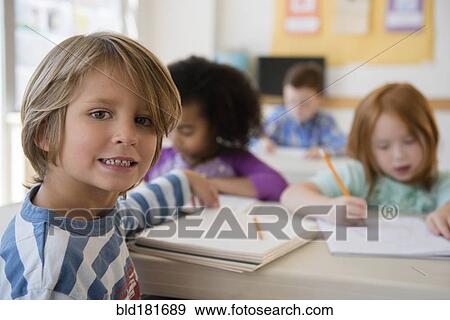 Stock Photo - Student smiling in classroom. Fotosearch