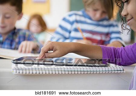 Student using digital tablet in classroom View Large Photo Image Stock Image - Student using digital tablet in classroom. Fotosearch