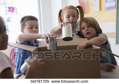 Stock Photography - Students donating canned goods in classroom. Fotosearch