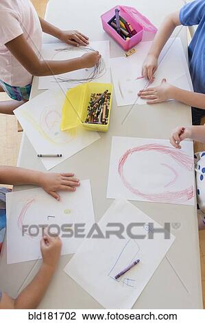 Stock Image - Students drawing in classroom. Fotosearch