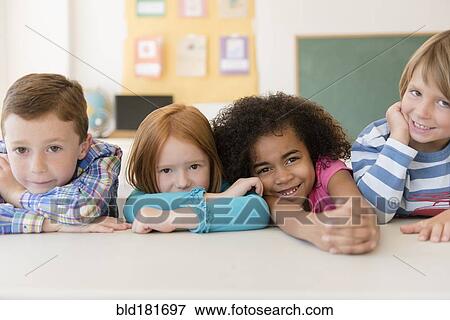 Stock Photo - Students smiling in classroom. Fotosearch