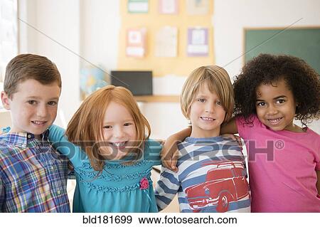 Stock Photo - Students smiling in classroom. Fotosearch