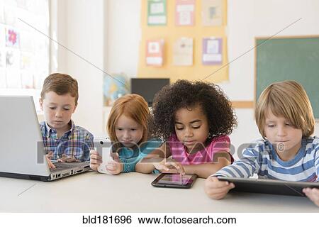 Stock Photograph - Students using technology in classroom. Fotosearch