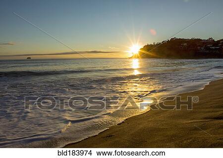 Sunset over horizon at remote beach View Large Photo Image Picture - Sunset over horizon at remote beach. Fotosearch