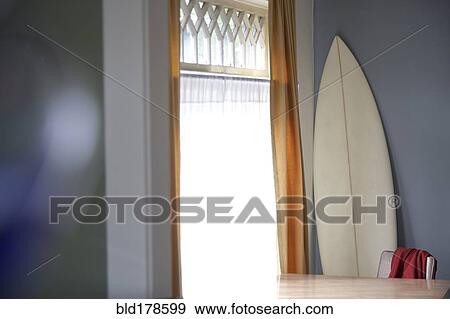 Surfboard and table at window View Large Photo Image Stock Photo - Surfboard and table at window. Fotosearch