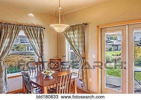 Stock Image - Table and windows in dining room. Fotosearch