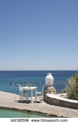 Table on balcony overlooking seascape View Large Photo Image Stock Photograph - Table on balcony overlooking seascape. Fotosearch