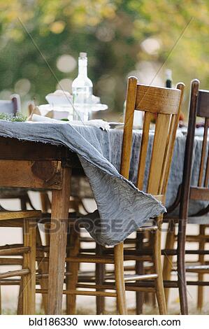 Tablecloth on empty table blowing in wind View Large Photo Image Stock Image - Tablecloth on empty table blowing in wind. Fotosearch