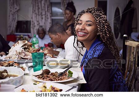 Teenage girl smiling at dinner table View Large Photo Image Stock Image - Teenage girl smiling at dinner table. Fotosearch