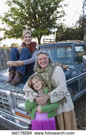 Three generations of Caucasian women sitting on truck View Large Photo Image Picture - Three generations of Caucasian women sitting on truck. Fotosearch