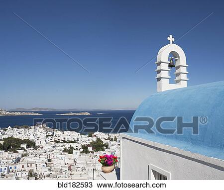Stock Image - Traditional church and Mykonos cityscape, Cyclades, Greece. Fotosearch