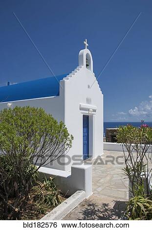 Stock Photograph - Traditional church entrance and walkway under blue sky. Fotosearch