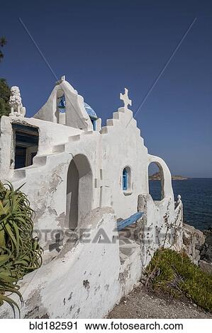 Stock Image - Traditional church on rocky oceanfront. Fotosearch
