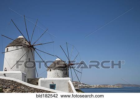 Stock Image - Traditional windmills under blue sky. Fotosearch