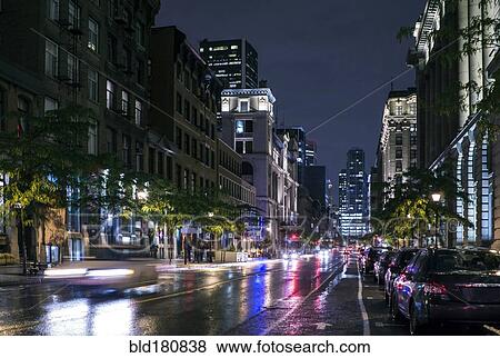 Stock Photo - Traffic in wet cityscape at night. Fotosearch