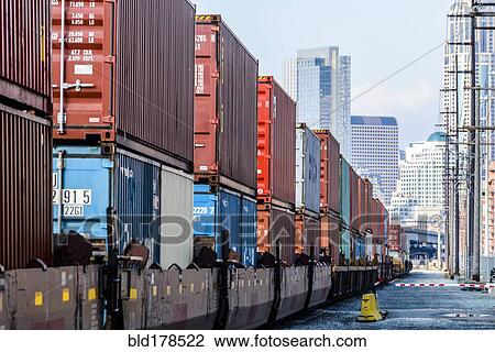 Stock Image - Train carrying containers on train tracks. Fotosearch