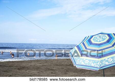 Stock Photography - Umbrella on beach under blue sky. Fotosearch