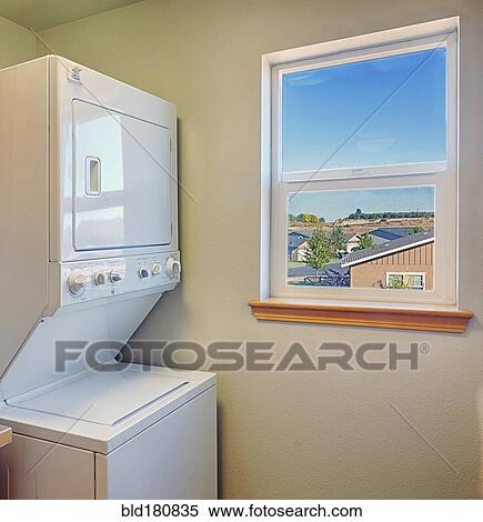 Stock Photography - Washer and dryer with window in laundry room. Fotosearch