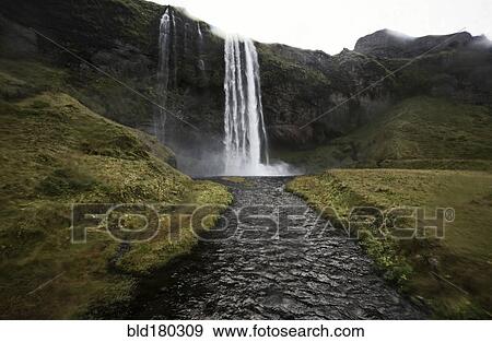 Stock Photo - Waterfall pouring over rocky cliff. Fotosearch