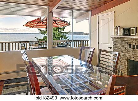 Stock Image - Window with lake view in dining room. Fotosearch
